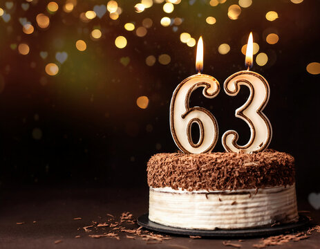 Birthday cake with 63 years birthday candle on dark background with bokeh. copy space