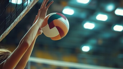 A close-up shows a volleyball player's hands spiking the ball, highlighting their skill and intensity.