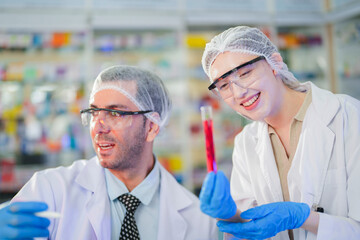 scientists perform experiments and record data. people arranges equipment with test tubes and chemicals for producing medicine and biochemistry. man hold tubes of chemical liquids and plant samples.