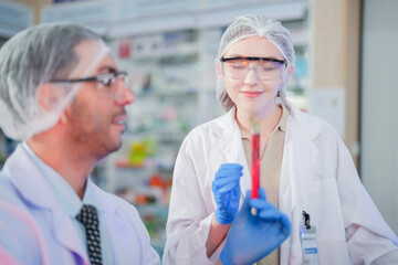 scientists perform experiments and record data. people arranges equipment with test tubes and chemicals for producing medicine and biochemistry. man hold tubes of chemical liquids and plant samples.