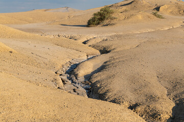 Arid landscape near Berca, Buzau, Romania, showcasing a rare European geological phenomenon. Here, gases from the earth emerge through the hills, creating small mud volcanoes and distinctive landscape
