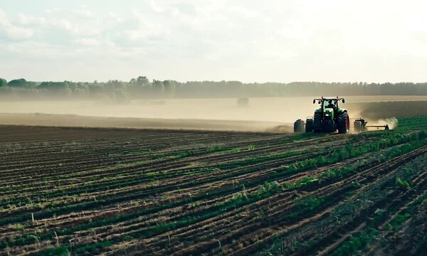 Tractor spray fertilize on field with chemicals in agriculture field.