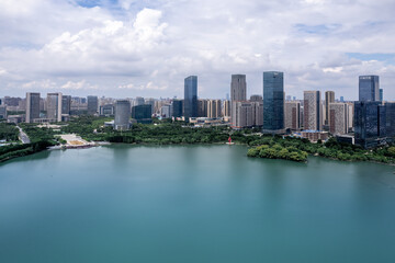 Naklejka premium Aerial View of Modern Cityscape with Serene Lakeside Landscape