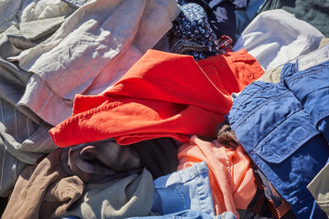 A bin of old clothes in a flea market, Cuneo, Piedmont, Italy