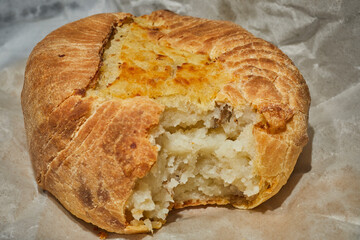 A backed potato knish from Knish Nosh in Rego Park, Queens, New York, USA