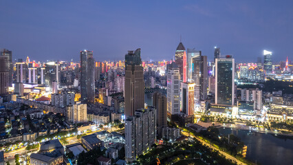 Fototapeta premium Vibrant Nightscape of a Modern Urban Skyline Illuminated by City Lights