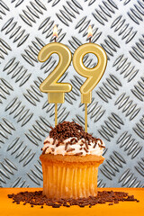 Birthday candle number 29 - Industrial metallic background.
