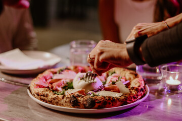 cutting into pizza couple dinner