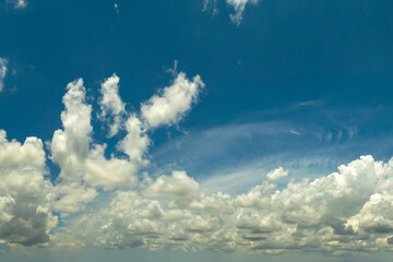 Blue sky with white summer rain clouds. Colorful summer landscape
