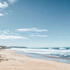 Tranquil beach with white sand and blue water under a clear sky.