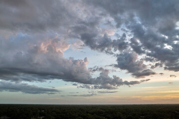 Colorful evening landscape with soft pastel coloured cloudscape on watercolor tinted sunset sky. Abstract nature background