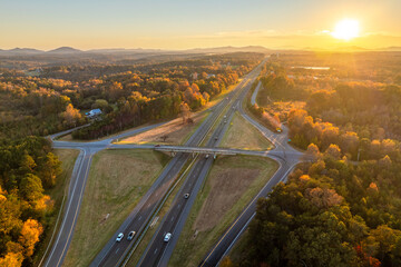 Elevated view of freeway exit junction over road lanes with fast moving traffic cars and trucks at...