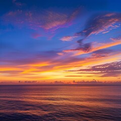 Vibrant orange and purple sunset over a calm ocean.