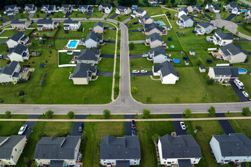 Obraz premium Low-density two story private homes in rural residential suburbs outside of Rochester, New York. Upscale suburban houses with large lot size and green grassy lawns in summer season