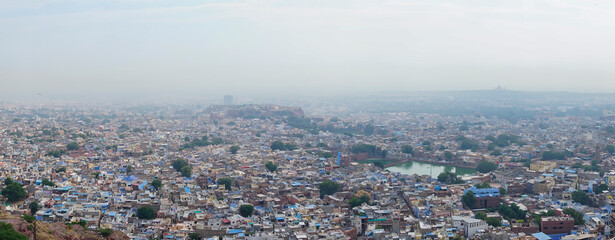 Panoramic view of Jodhpur city as seen from famous Mehrangarh fort, Jodhpur, Rajasthan, India. Blue sky in background. Mehrangarh Fort is UNESCO world heritage site popular amongst tourists worldwide.