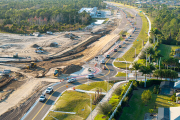 Roadworks construction site at roundabout intersection on American highway. Development of city...