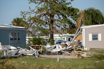 Severely damaged houses after hurricane Ian in Florida mobile home residential area. Consequences...