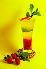 A refreshing strawberry squash drink served on a vibrant yellow and blue background, bursting with summer vibes and sweetness.