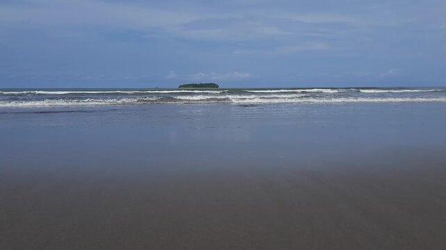 The atmosphere of small waves on the peaceful beach of Pariaman City, Indonesia