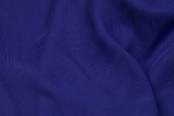Fototapeta premium Blue fabric background. Blue cloth waves background texture. Blue fabric cloth textile material.