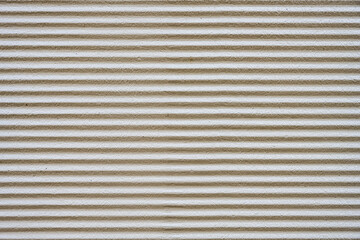 Background from a gray plastered wall with a corrugated profile