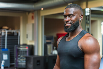 Personal fitness trainer smiling in the gym with copy space