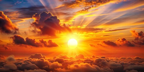 Obraz premium Vibrant sunset with fluffy clouds and a glowing orange sun