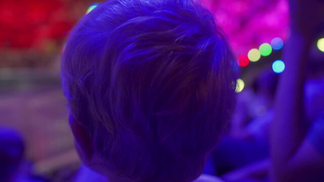 Spectators in a circus. Small child little boy watching a circus performance. Simferopol, Crimea, Russia 2024