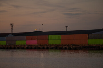 Dark colorful shipping containers in the port of Riga in Latvia. Andrejsala location during evening sunset