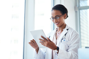 Doctor, tablet and happy woman reading for research, info and healthcare update in hospital. Digital technology, medical professional and check schedule, report or results for telehealth on internet - Powered by Adobe