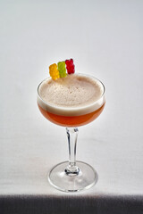 A playful and fun cocktail garnished with colorful gummy bears