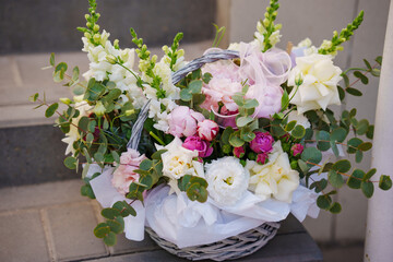 A delicate and beautiful bouquet of roses, peonies and orchids.