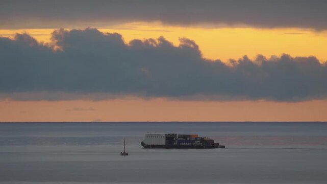 Container ship on the ocean viewed from a distane in 4k