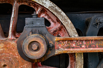 Rusty steam train detail weathered wheels and machinery in a historical railway settingbackround