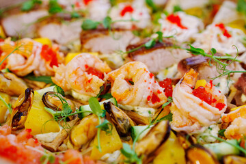 A box with an assortment of meat and fish appetizers for the buffet table. 