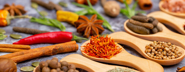 A set of spices on a gray background. Variety of spices from India. Food decoration design. Various...