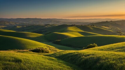 Fototapeta premium Rolling green hills with golden sunset in the sky.