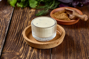 Creamy Garlic Sauce in Rustic Setting on Wooden Background
