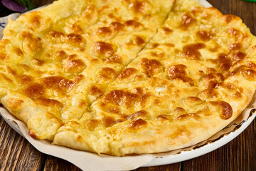 Traditional Megrelian Khachapuri Cheese Bread on Rustic Wooden Table