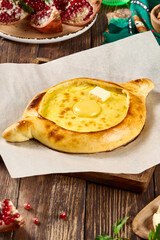 Rustic Adjarian Khachapuri with Egg and Butter on Wooden Table