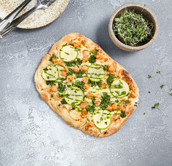 Gourmet Roman Zucchini and Salmon Pizza on Grey Stone Background