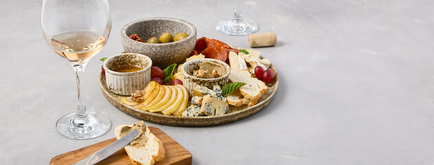Elegant Cheese and Wine Platter with Olives, Sundried Tomatoes, Pear, Honey, Fuet Sausage, and Pâte