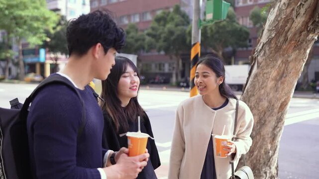 In an alley in Da'an District, Taipei, a slow-motion video shows a Taiwanese man and woman with a South Asian woman in their twenties, chatting amicably.