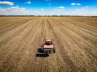 tractor with fertilizer spreader on field