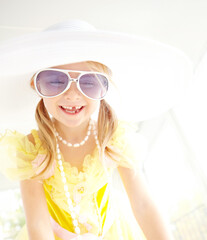 Fancy, dress and girl child in home with fun, glamour and confident smile with sunglasses for character play. Princess, costume and happy kid with laughing, fantasy game and creative development.