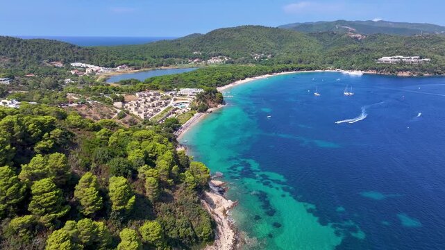 Panoramic aerial view of the bay of Koukounaries, with Ampelakia beach, watersports and the lake, Skiathos island, Greece