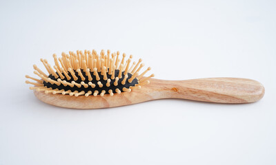 Hair loss fall with comb brush isolated on white background.