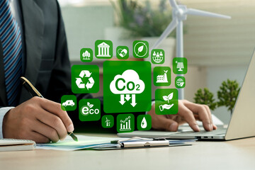 Reduce Co2 emission. Businessman using technology to lower CO2 emissions to limit global warming...