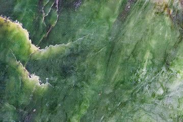 Abstract background made of natural mineral jade stone. Jade is a green stone.