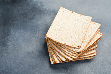 Jewish matzah bread. On a gray concrete background. Top view.